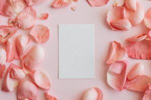 piece of paper among rose petals