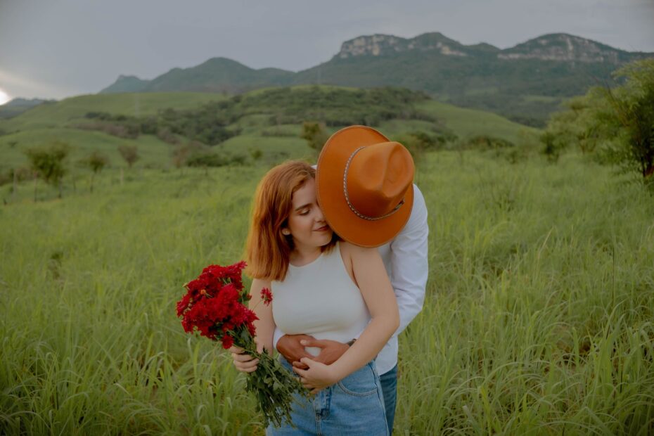 man embracing a woman holding flowers